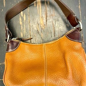 Authentic Dooney & Bourke light brown leather purse with dark brown handles.